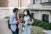 Diverse female teens standing near college building and chatting